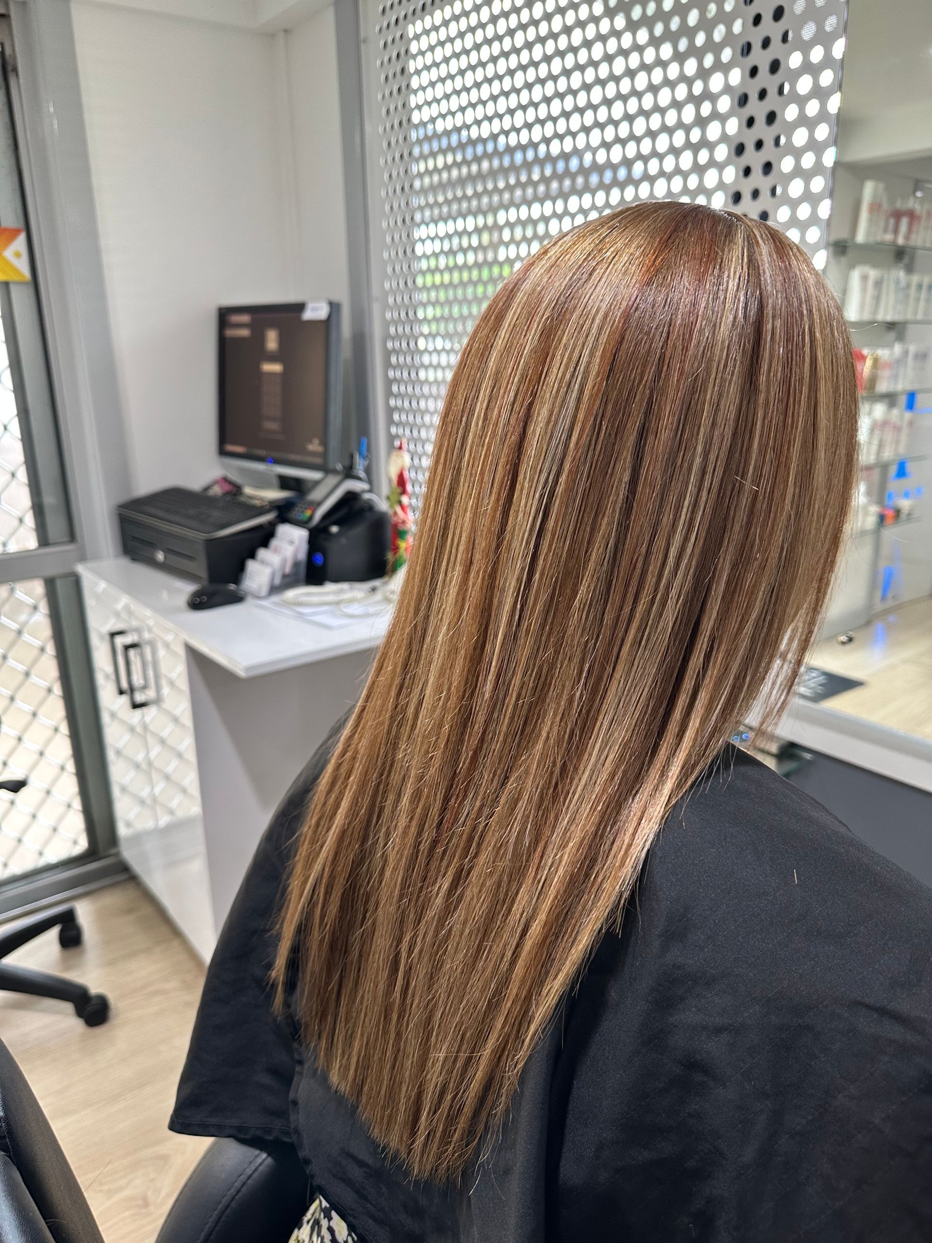 A Woman is Getting Her Hair Dyed in a Salon — Azure Hair in South Mackay, QLD