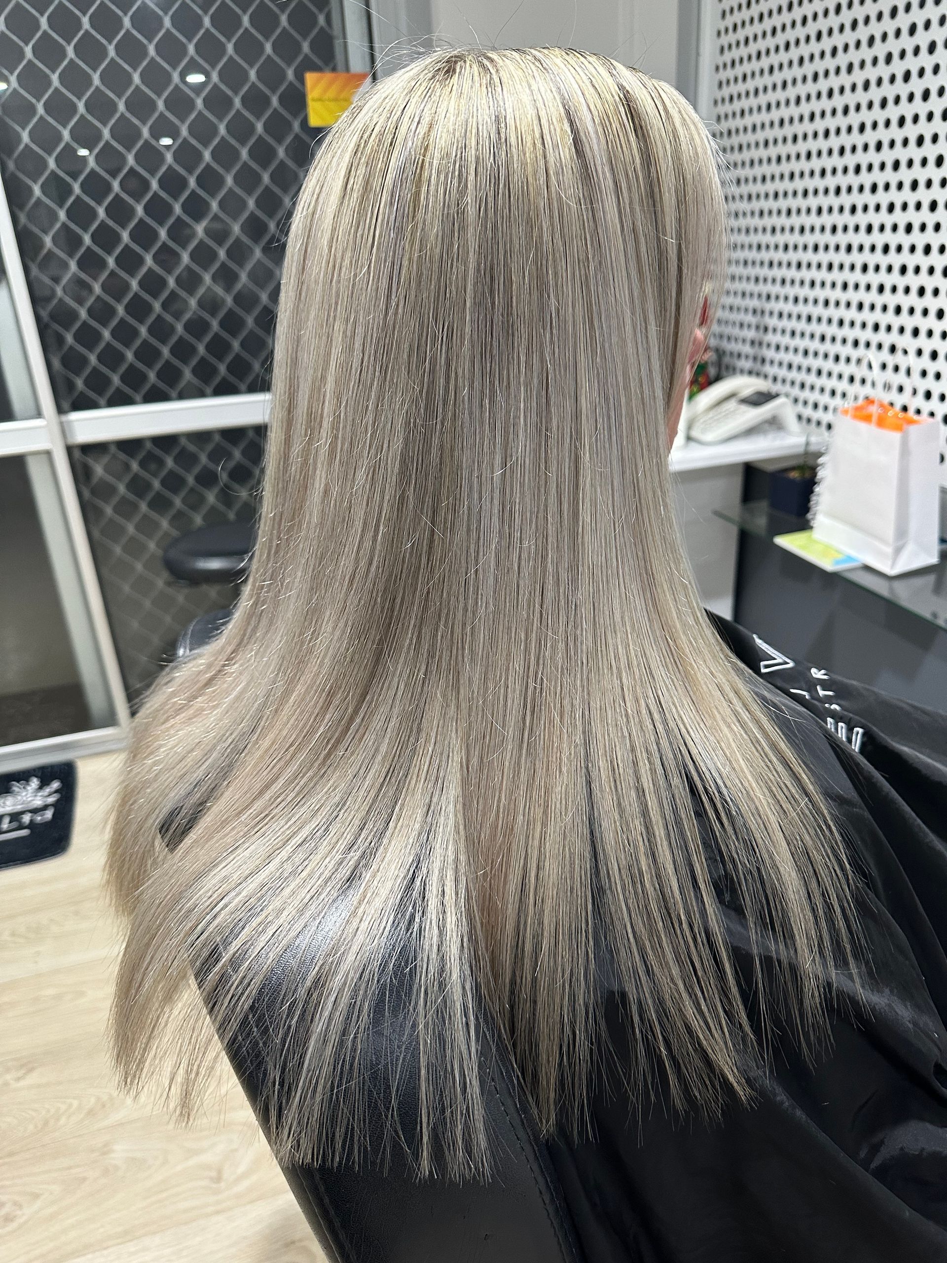 A Woman is Sitting in a Chair at a Hair Salon — Azure Hair in South Mackay, QLD
