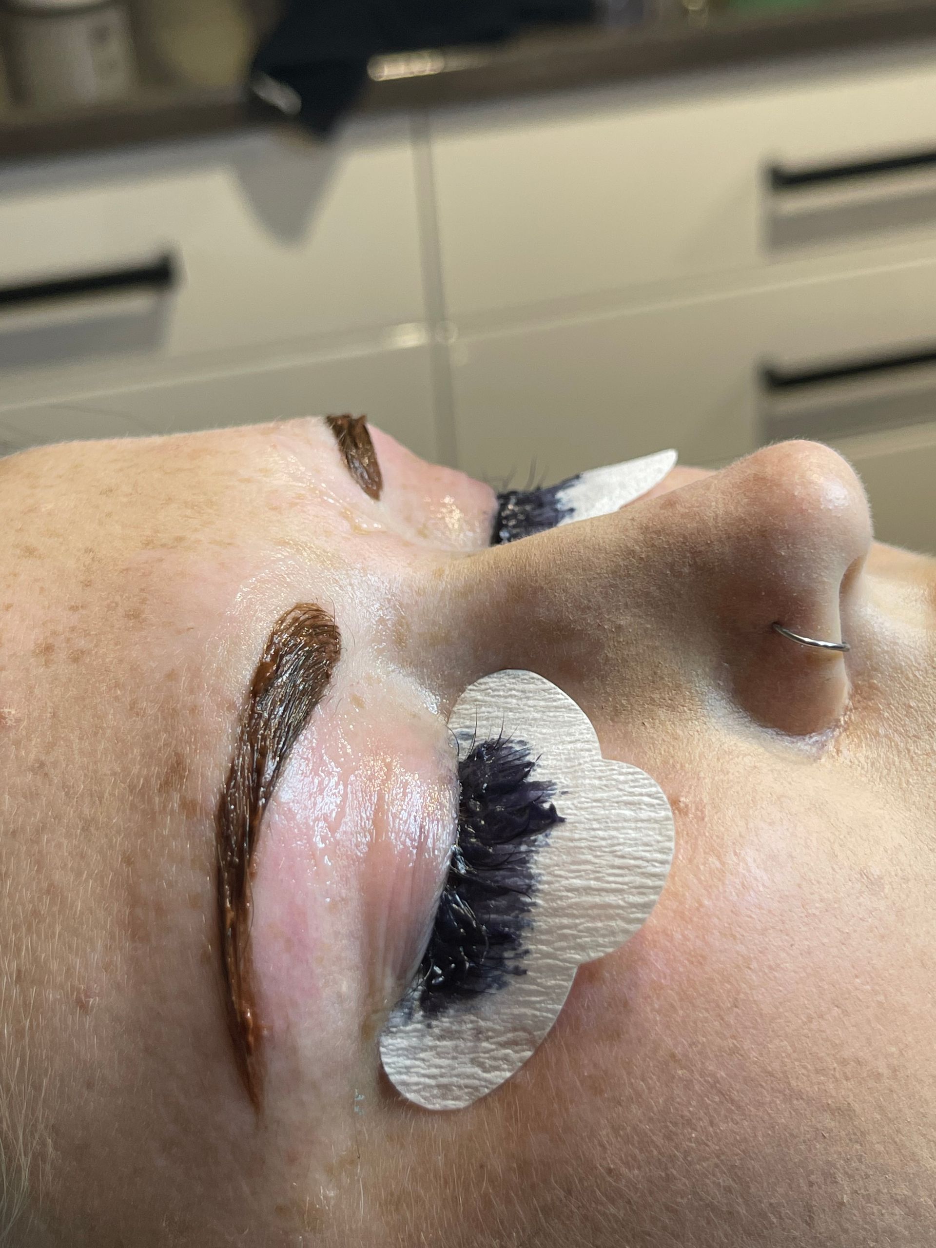 A Woman With Short Blonde Hair is Standing in Front of a Mirror — Azure Hair in South Mackay, QLD