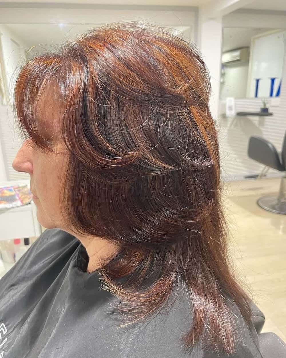 A Woman is Getting Her Hair Cut in a Salon — Azure Hair in South Mackay, QLD