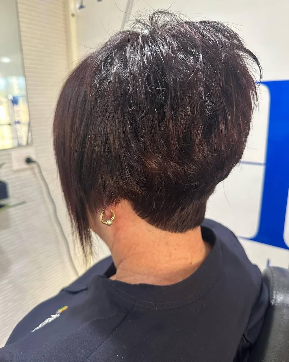 A Woman is Getting Her Hair Cut in a Salon — Azure Hair in South Mackay, QLD