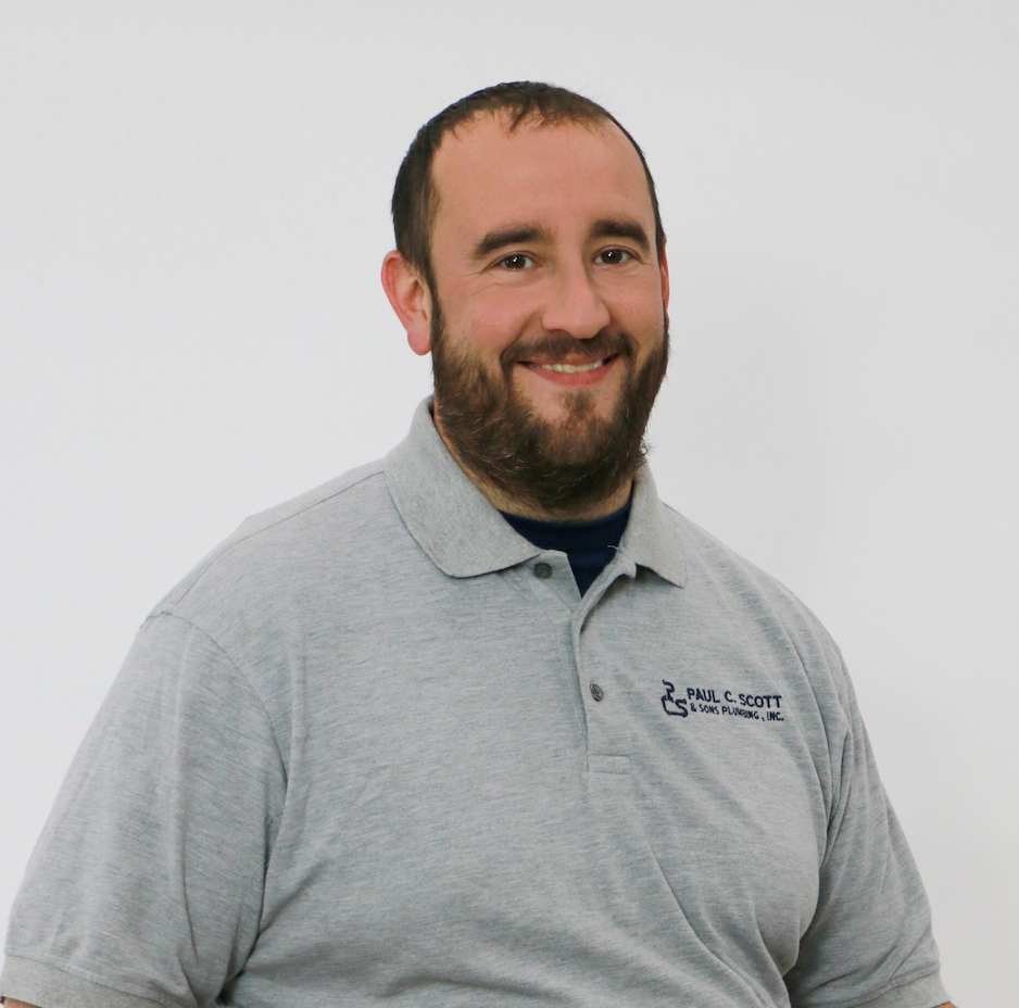 A man with a beard wearing a blue t-shirt with a handicap symbol on it