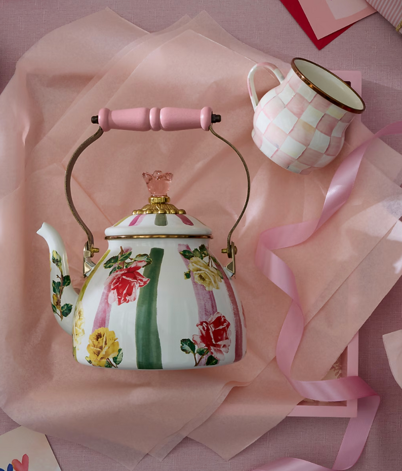Checkered reindeer figurines with red bows and gold antlers on a decorated table.