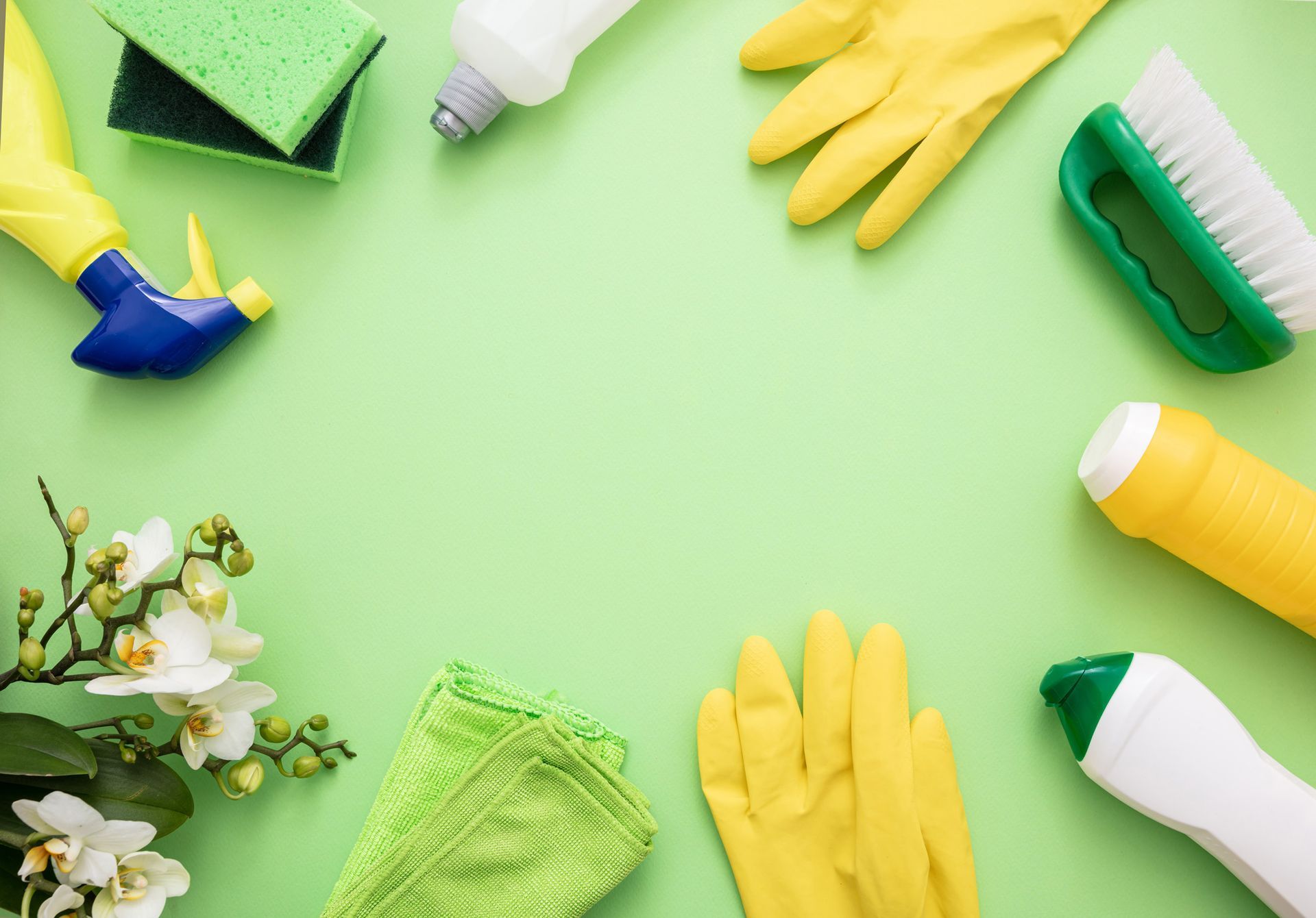 A green background with cleaning supplies and flowers in a circle.