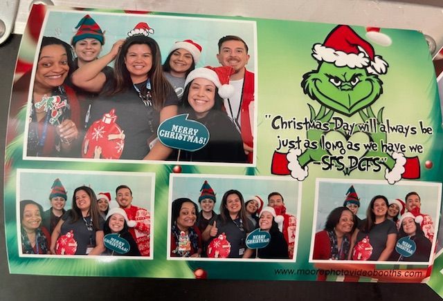 Christmas photo booth with groups of smiling people, Grinch, and festive decorations.
