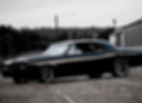 Black classic car parked, outdoors.