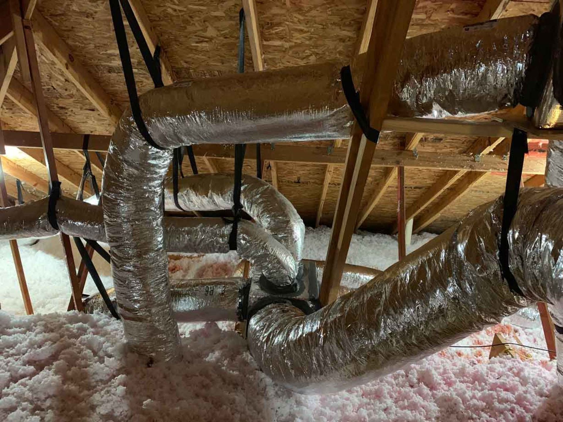 a bunch of pipes are hanging from the ceiling of a house .
