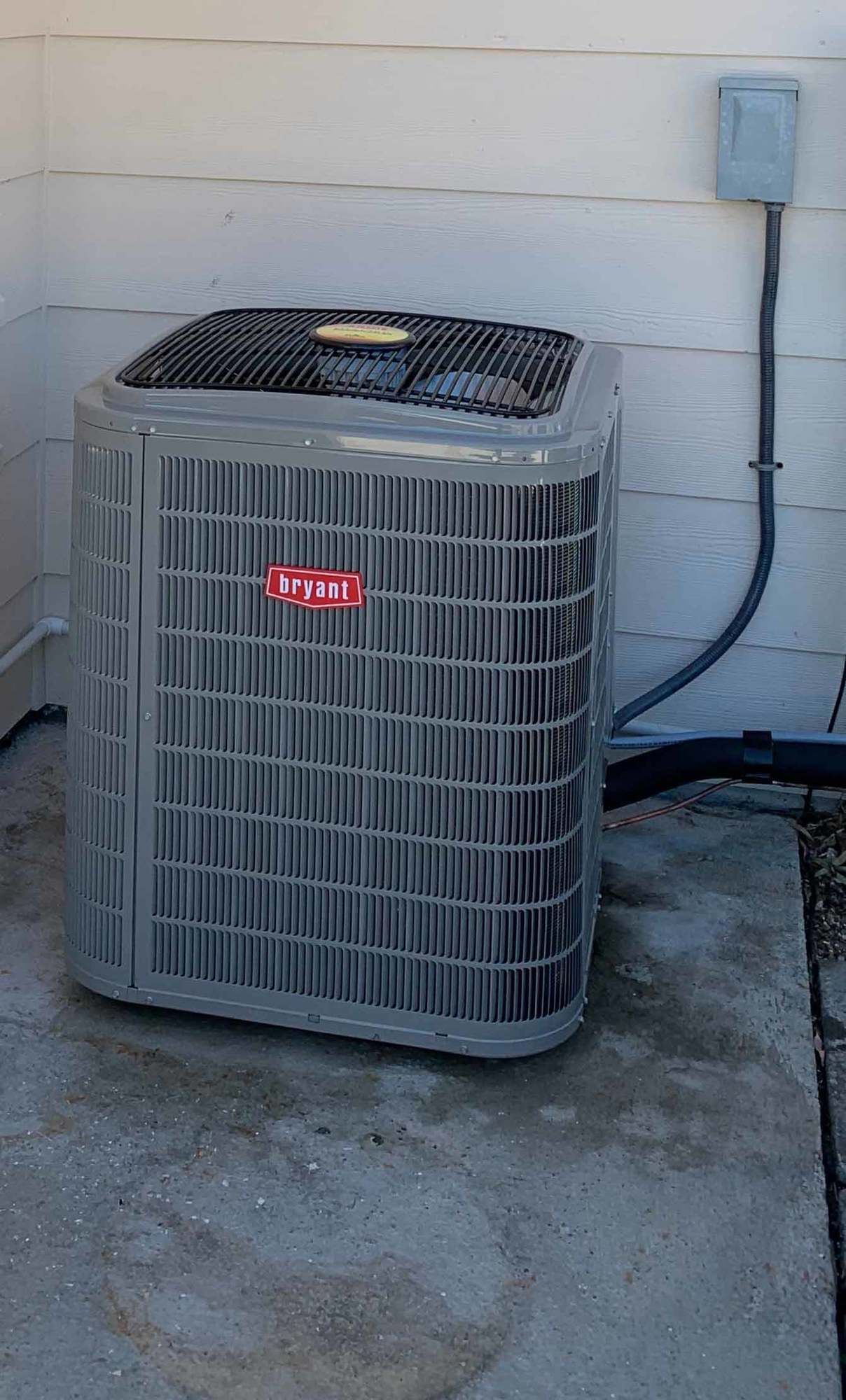 a large air conditioner is sitting on the side of a building .