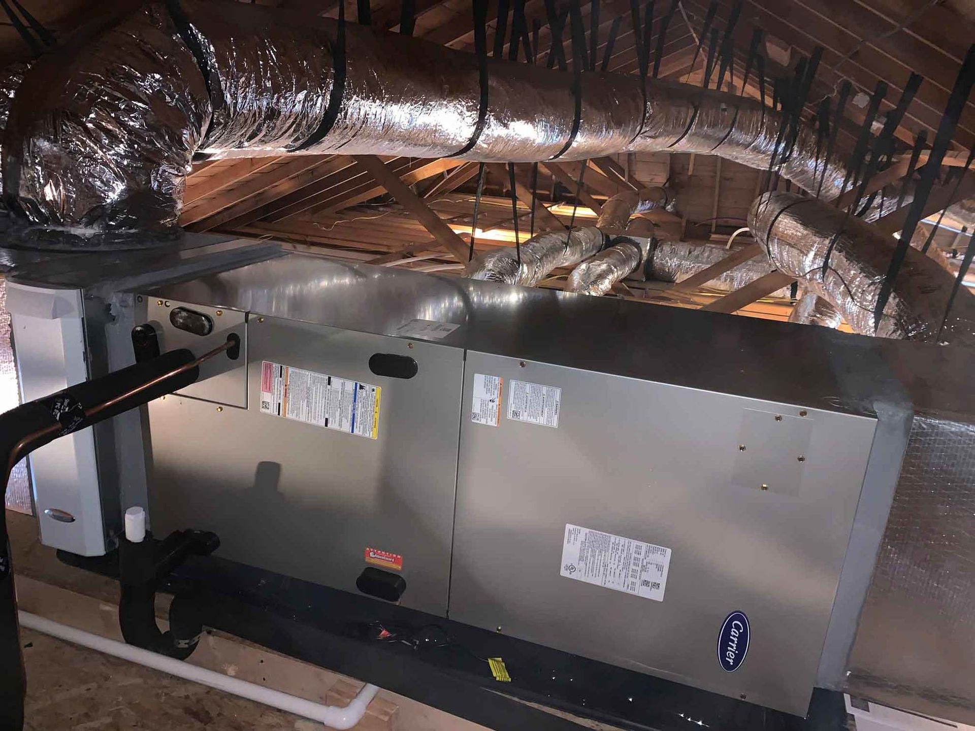 a large air conditioner is sitting in the attic of a house .