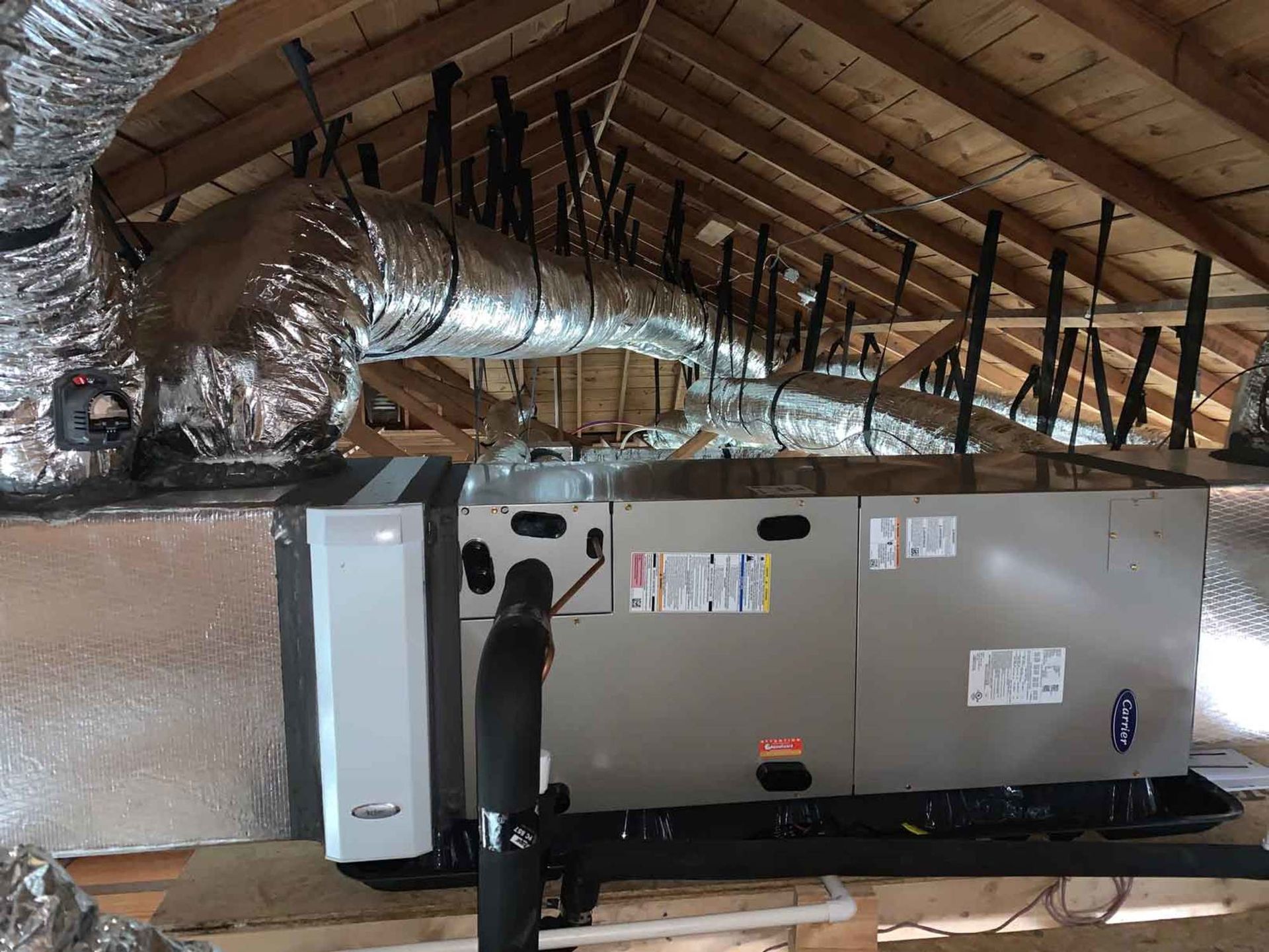 a large air conditioner is sitting in the attic of a house .