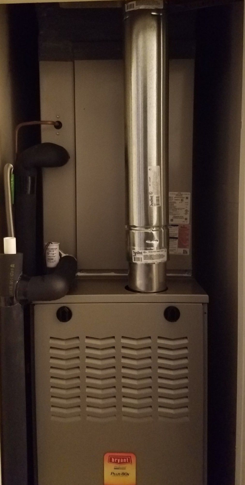a furnace is sitting in a closet next to a chimney .
