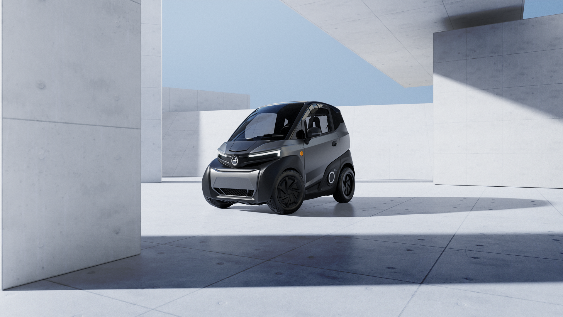 Una piccola automobile elettrica nera è parcheggiata in un parcheggio.