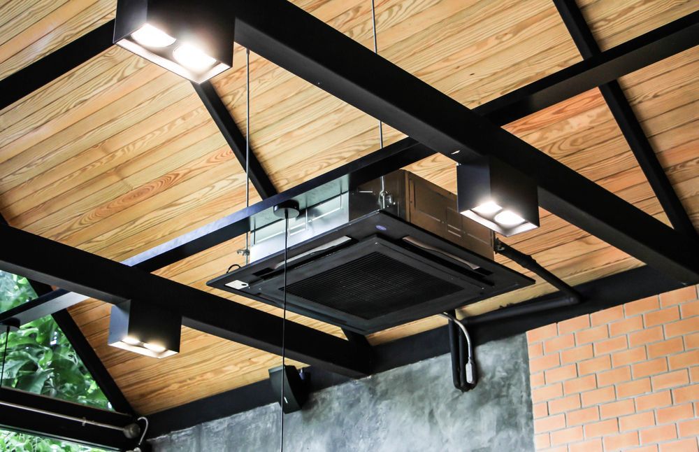A Ceiling Fan is Hanging From the Ceiling of a Building — Revive Air Conditioning in Liverpool, NSW