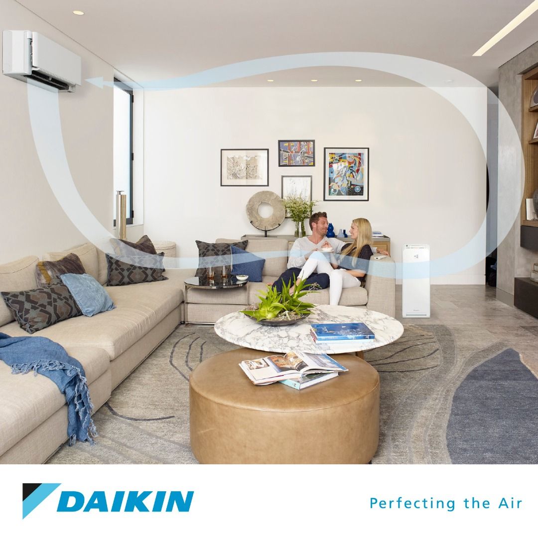 Couple in Front of An Air Conditioner — Revive Air Conditioning in Narellan, NSW