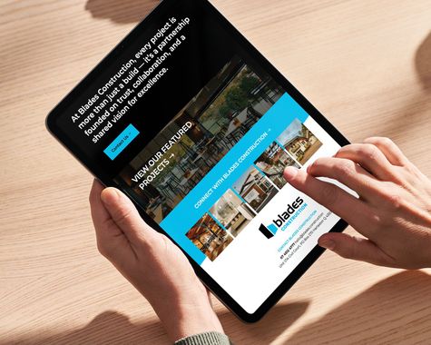 Hands using a tablet displaying a travel website with blue and white sections