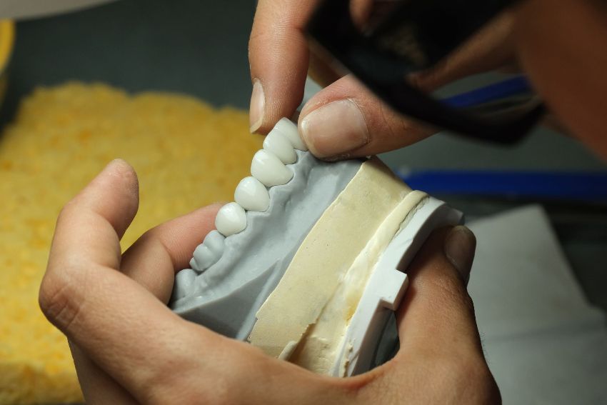 a person is working on a model of teeth