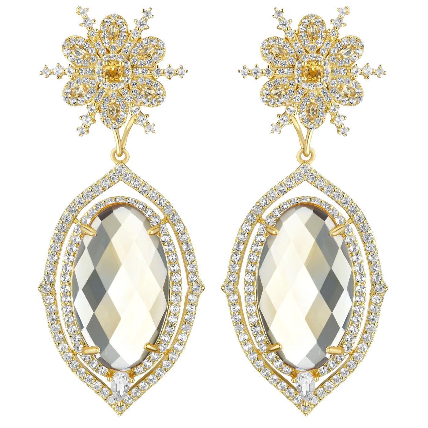 a pair of earrings with a large oval stone in the middle