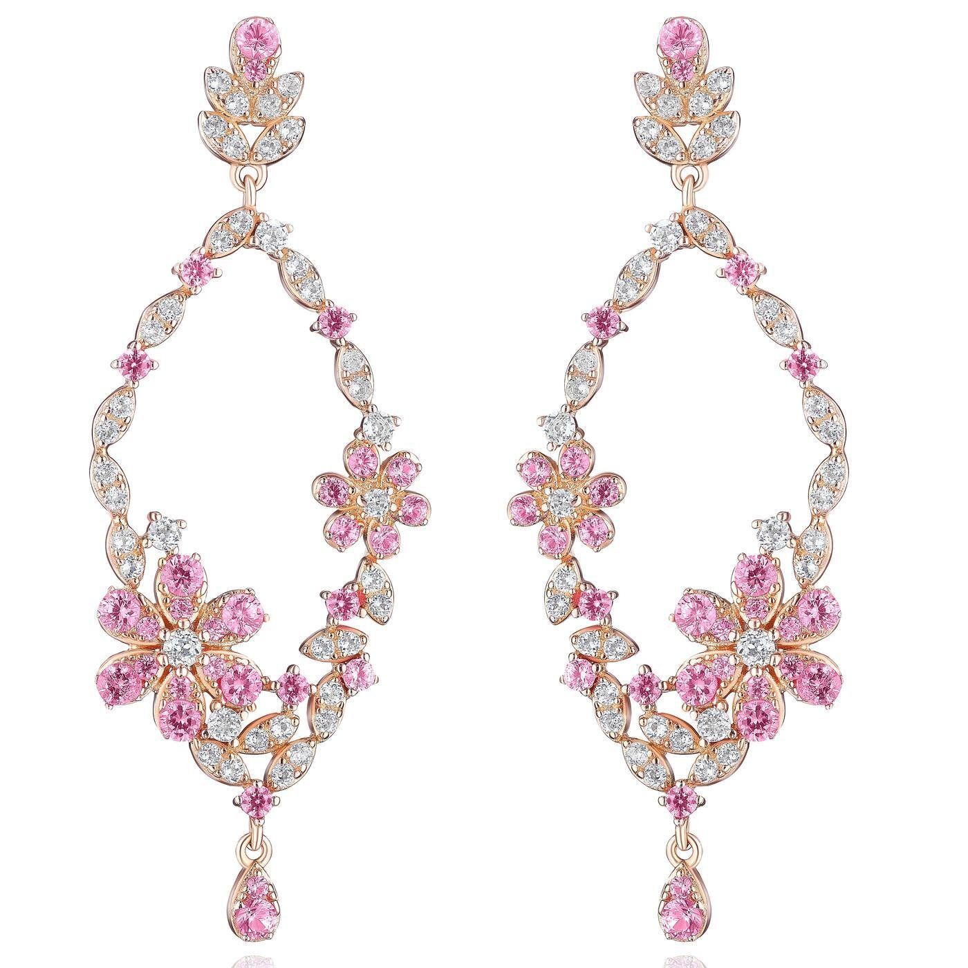 a pair of pink and white earrings on a white background