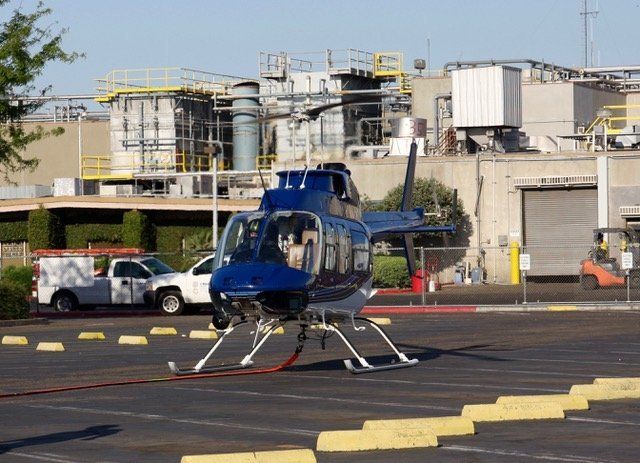 Helicopter With Lifting Sling — Sacramento, CA — Sacramento Executive Helicopters