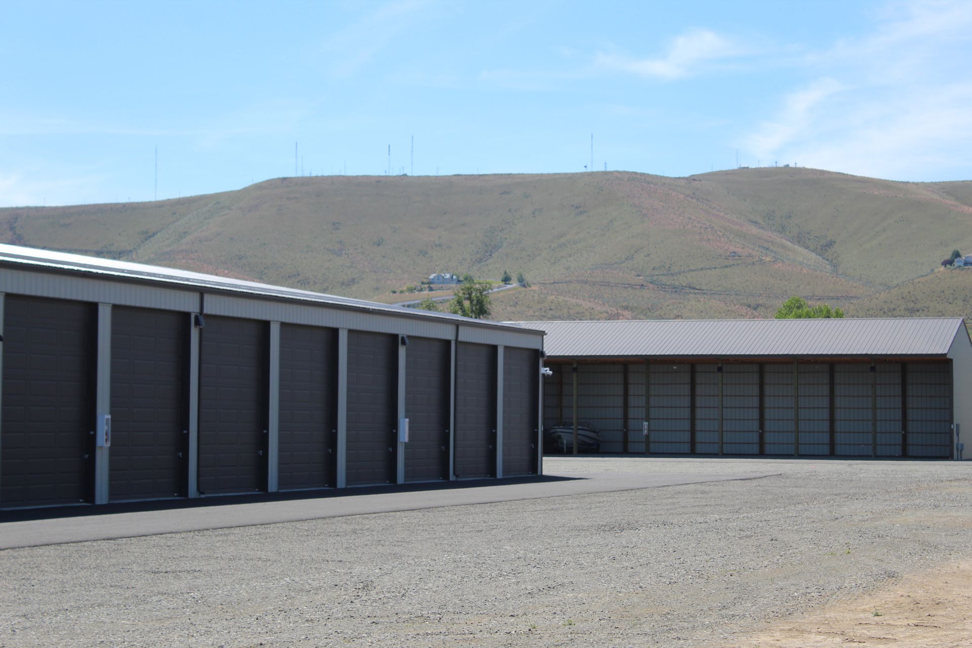 A row of storage units with mountains in the background