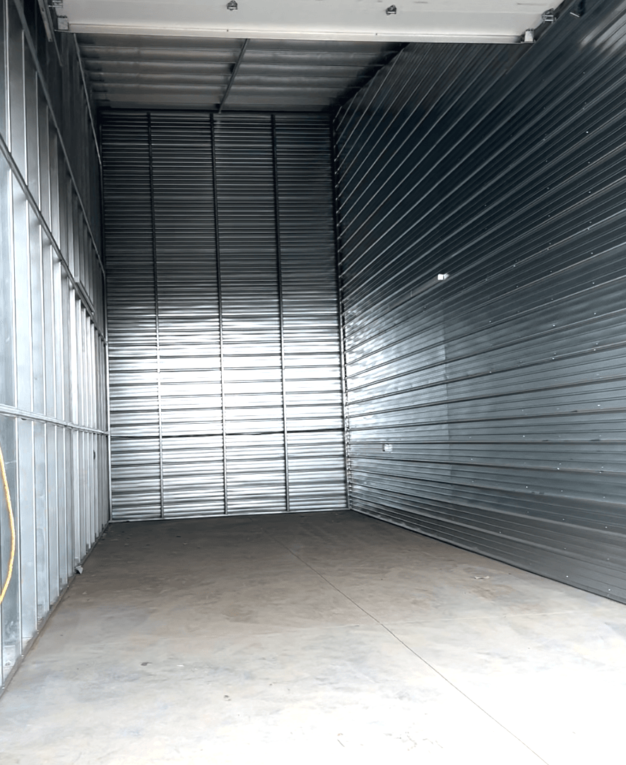 A large empty warehouse with a metal roof and walls.