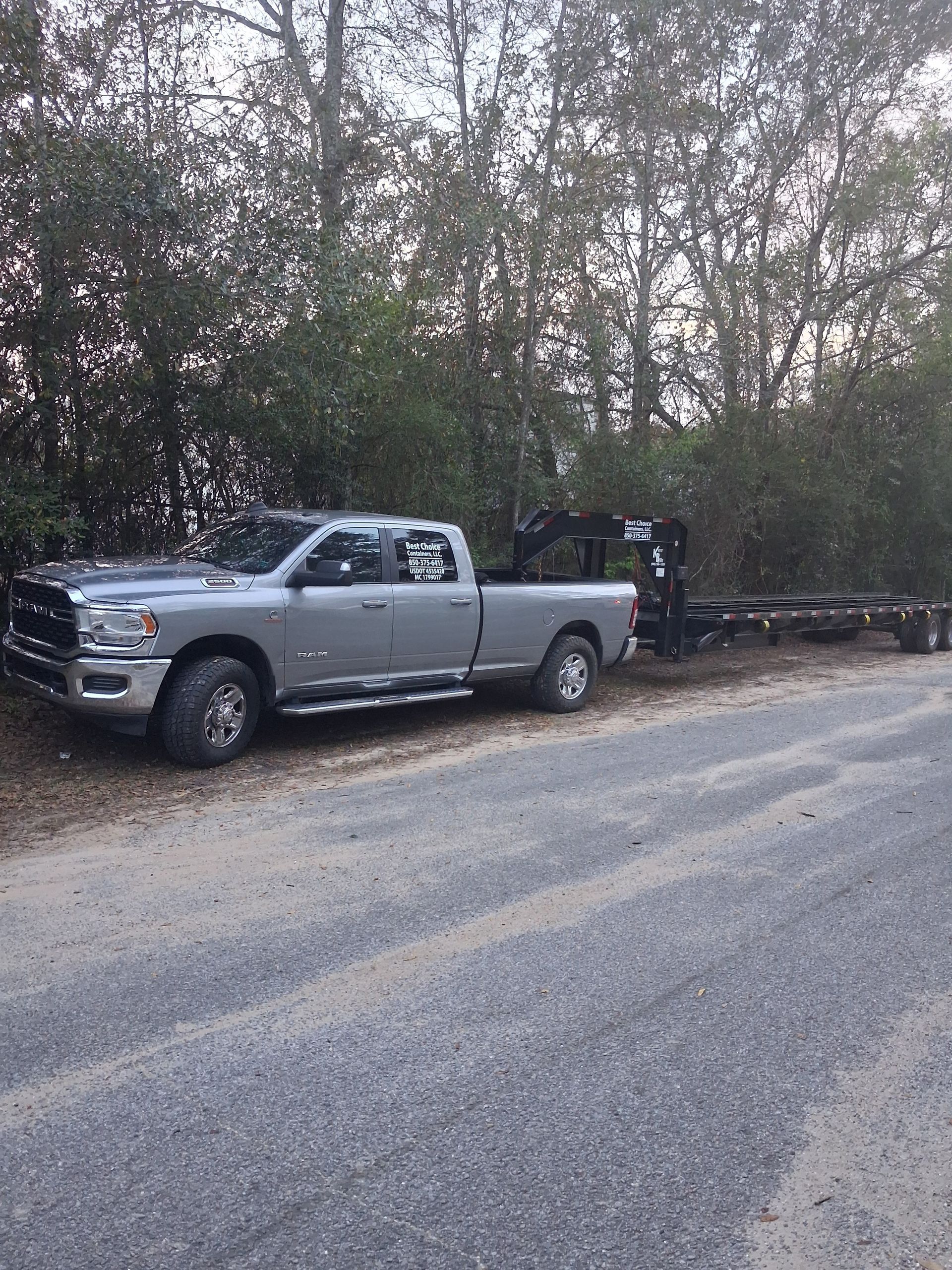 Two shipping containers are being loaded with boxes in a warehouse.