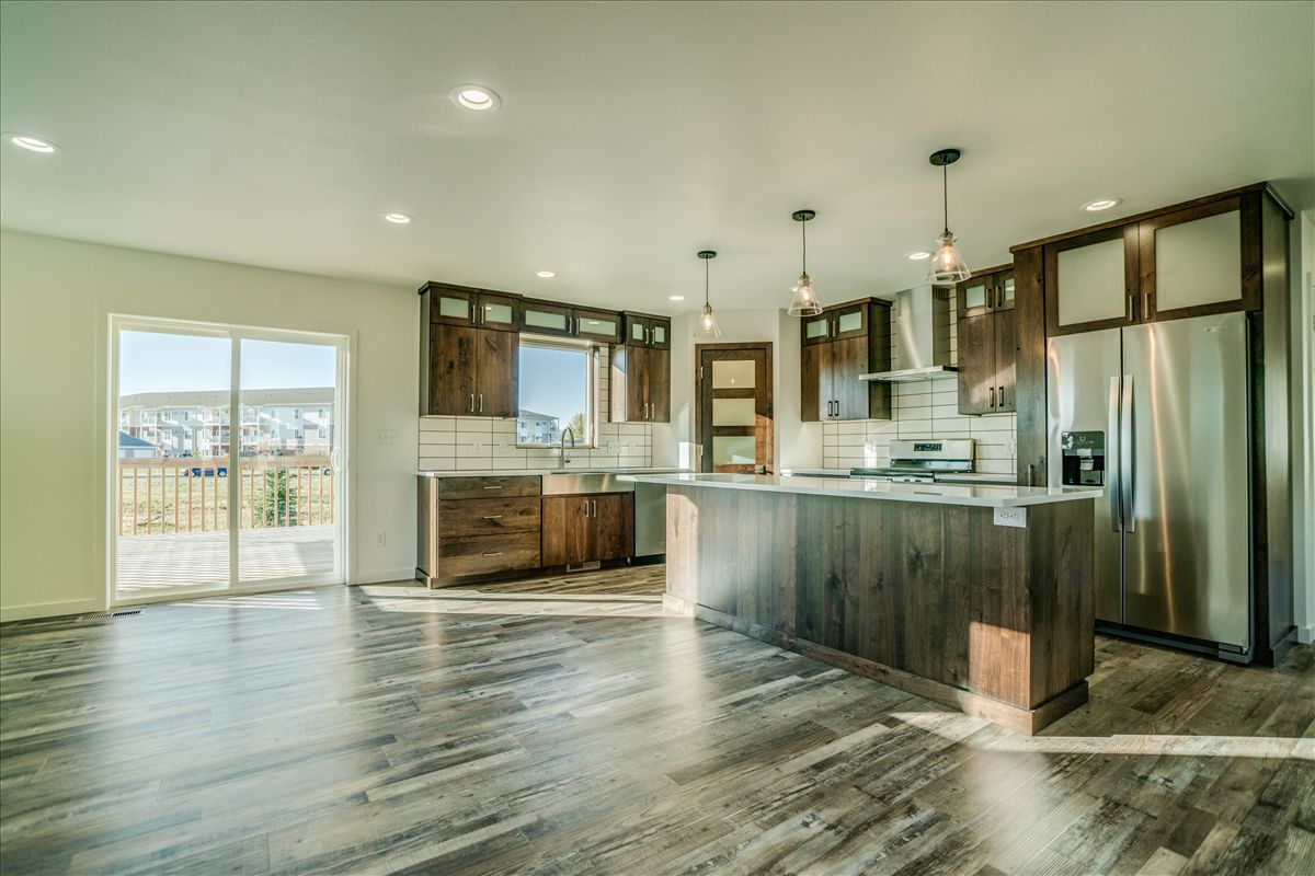 A living room with a large sectional couch and two coffee tables.
