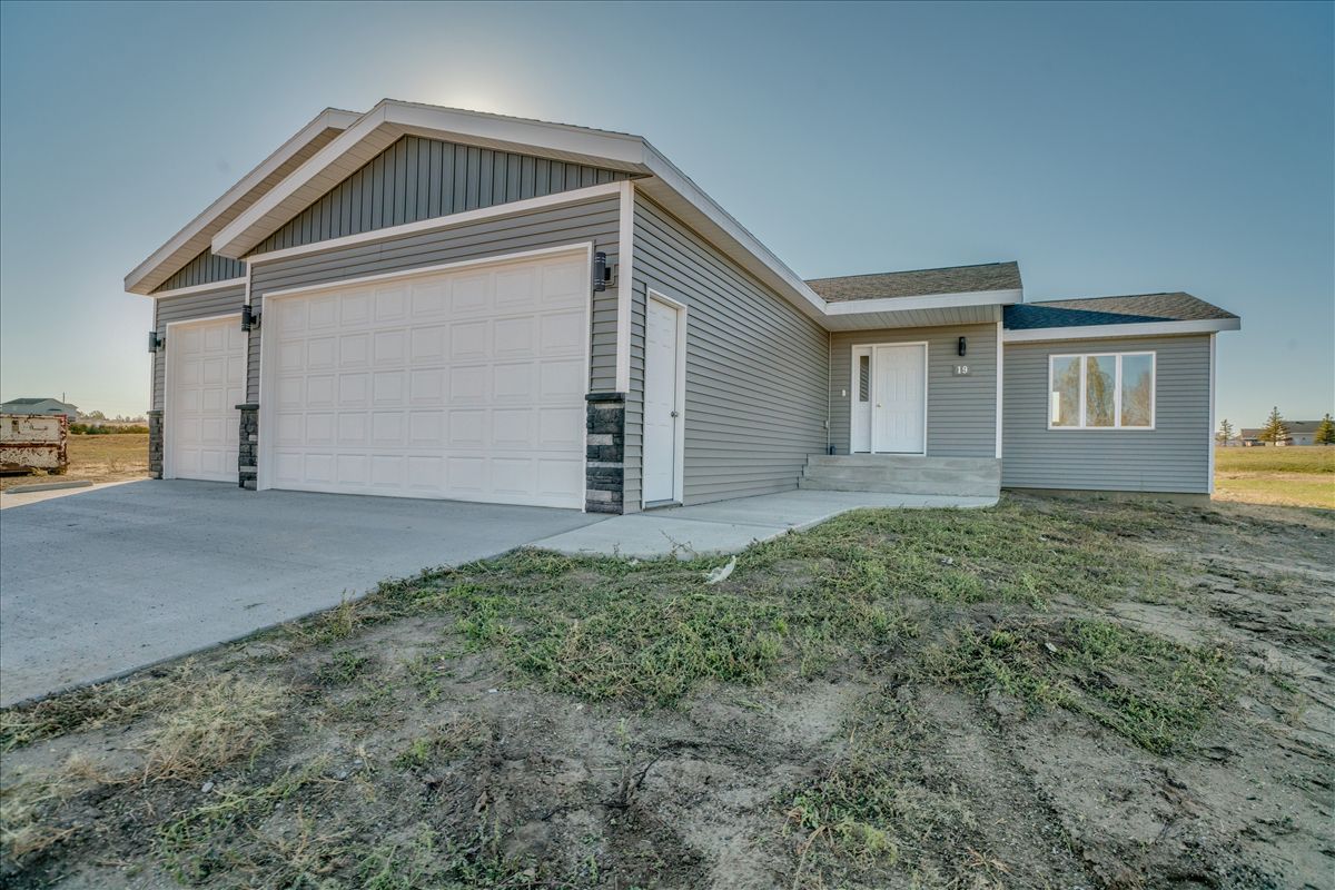 A living room with a large sectional couch and two coffee tables.