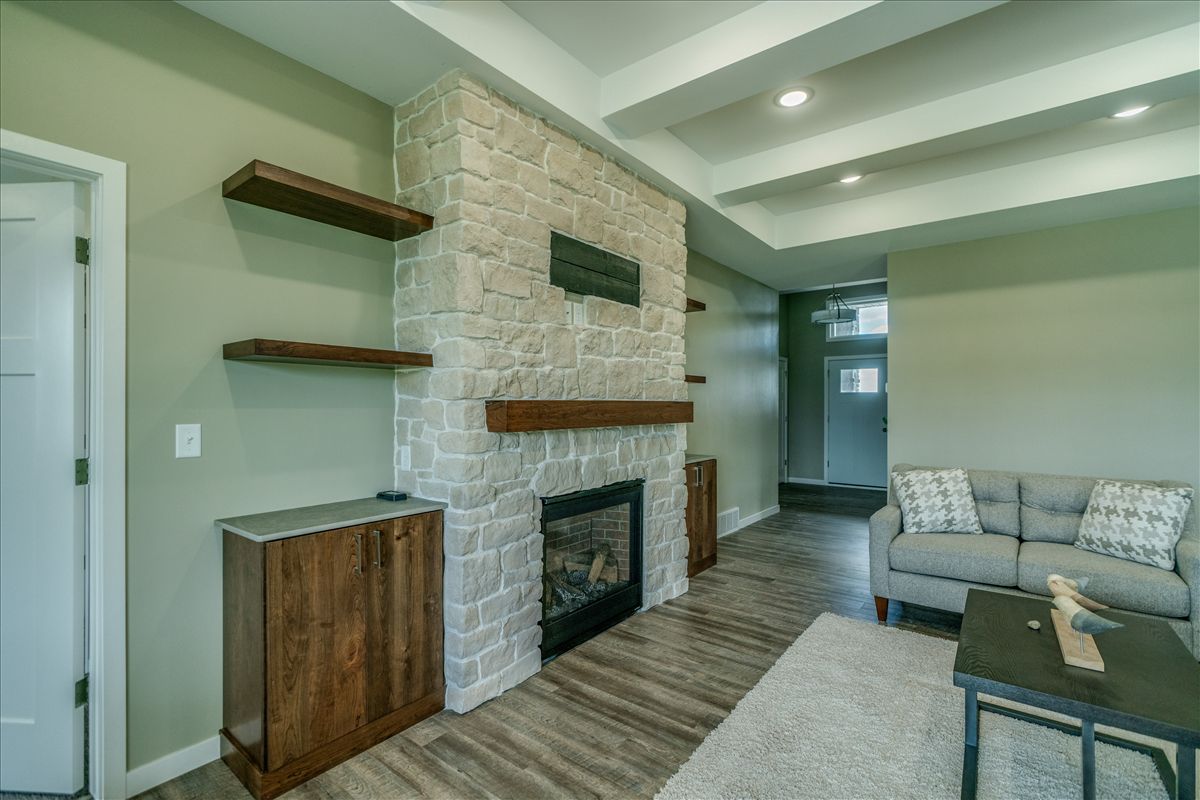A hallway in a modern apartment with marble floors and black walls.