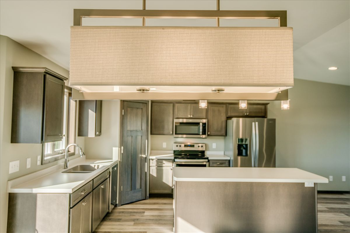 A hallway in a modern apartment with marble floors and black walls.