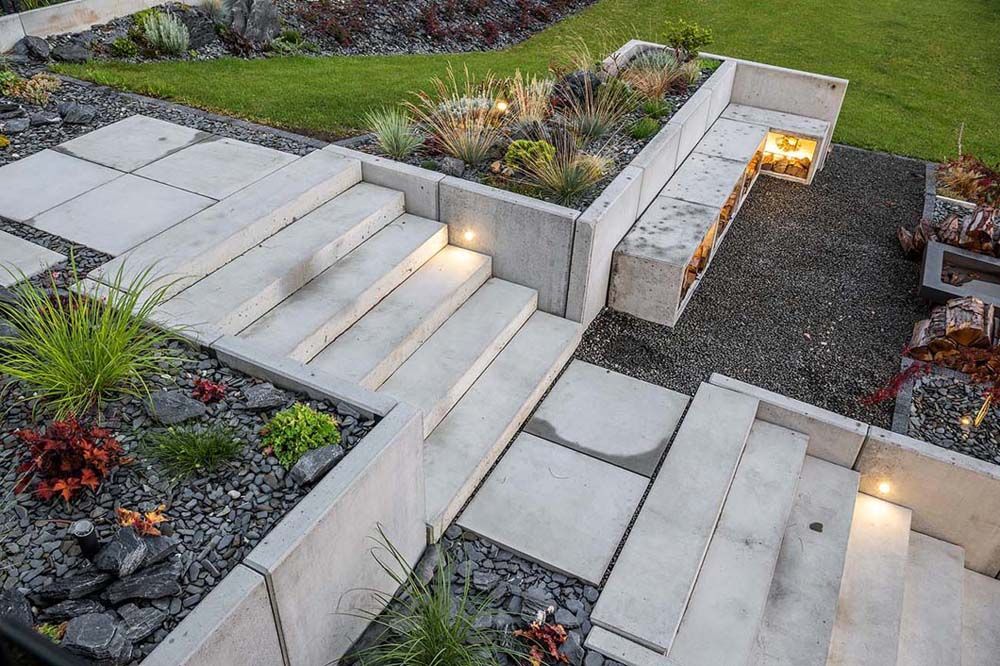 A set of stairs leading up to a bench in a garden.