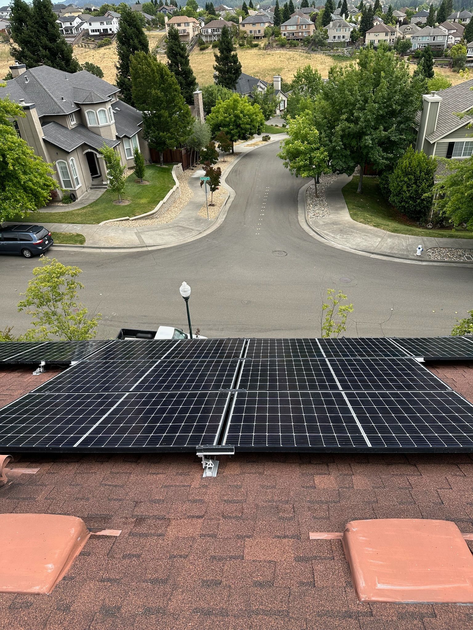 A wooden fence is sitting on top of a lush green field.