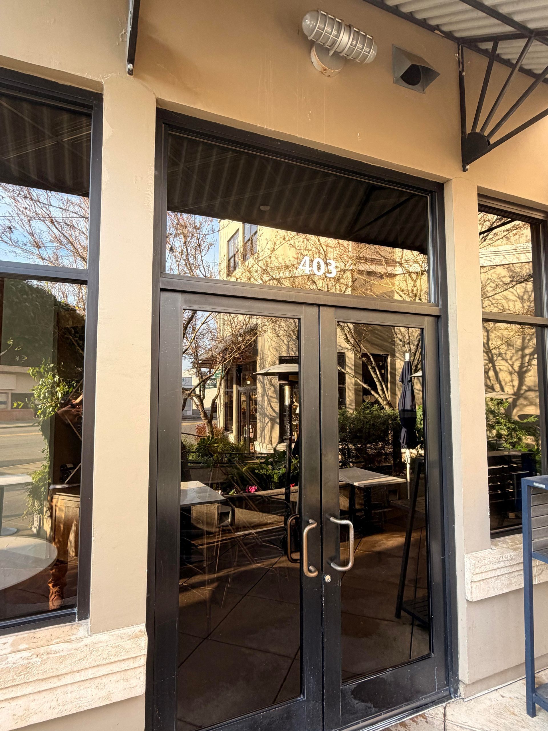 Exterior of a business with glass doors and windows. 