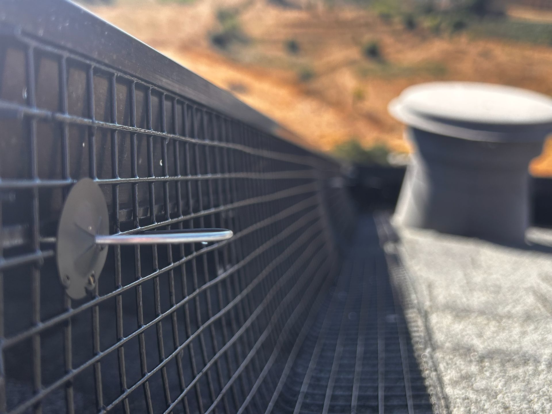 A wooden fence is sitting on top of a lush green field.