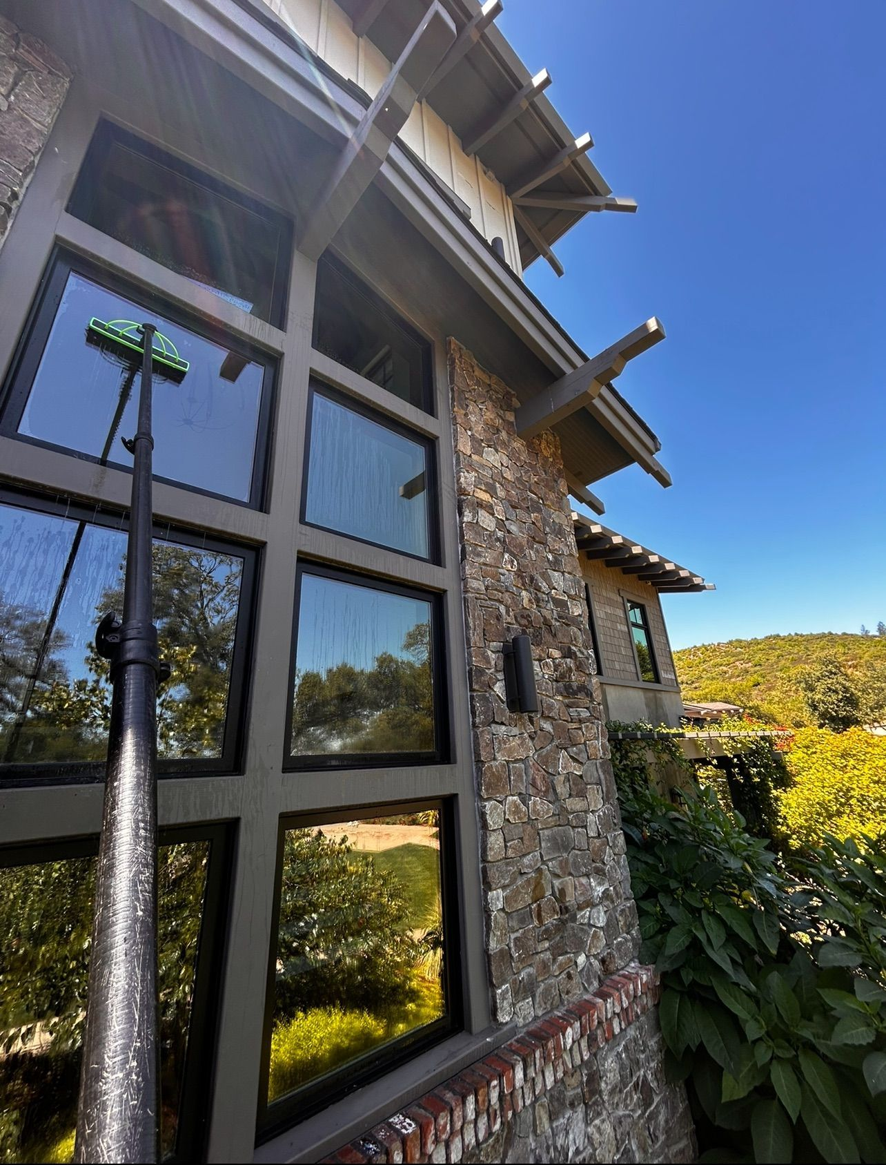 A wooden fence is sitting on top of a lush green field.