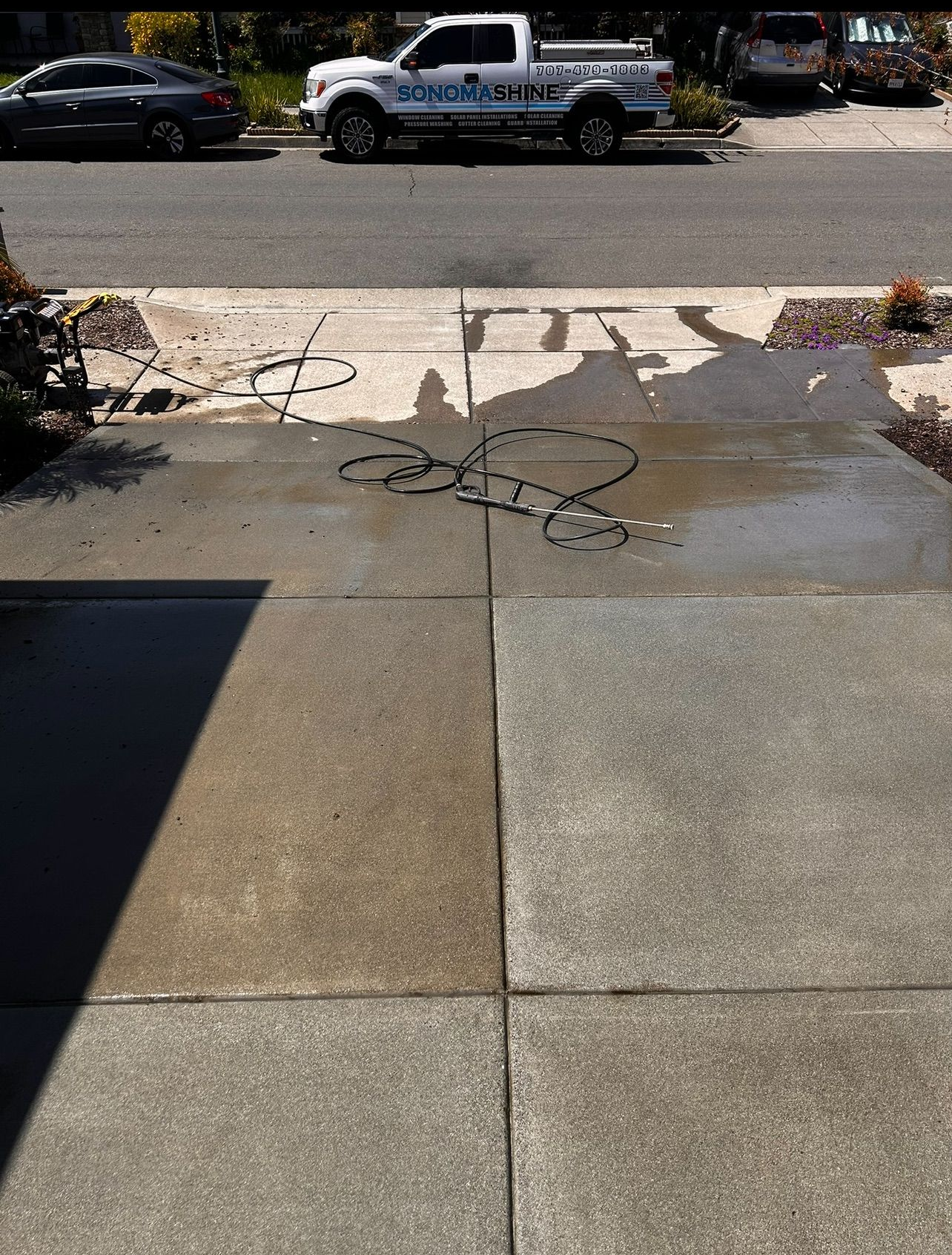A wooden fence is sitting on top of a lush green field.