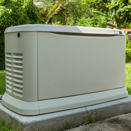 A white generator is sitting on top of a concrete block.