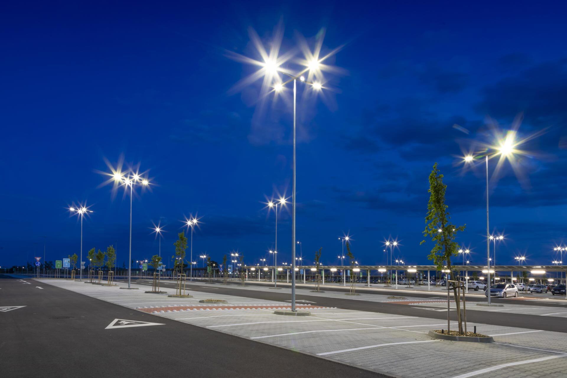 Big modern empty parking lot with bright LED street lights at night