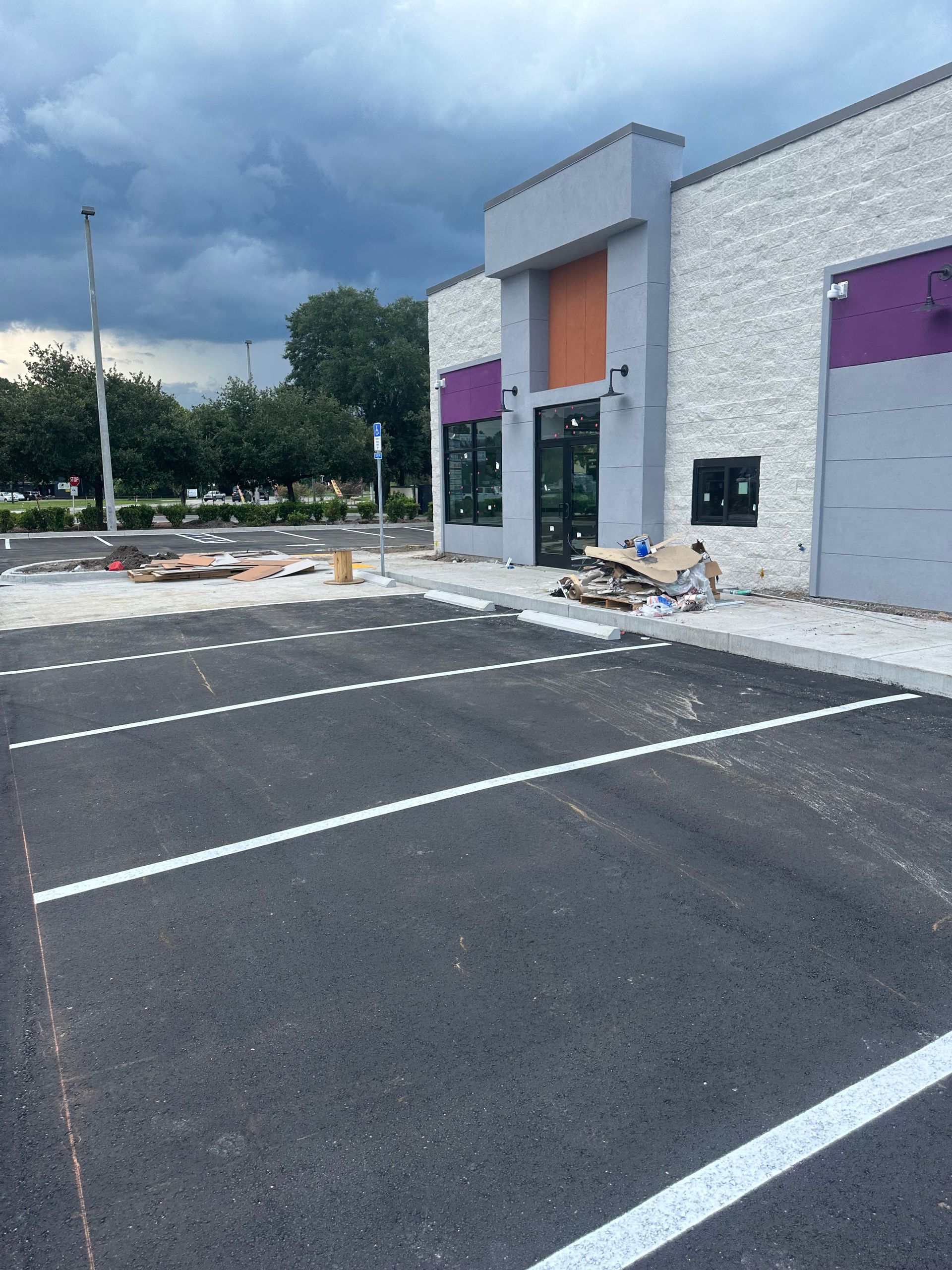 A machine is painting a white line on the road.