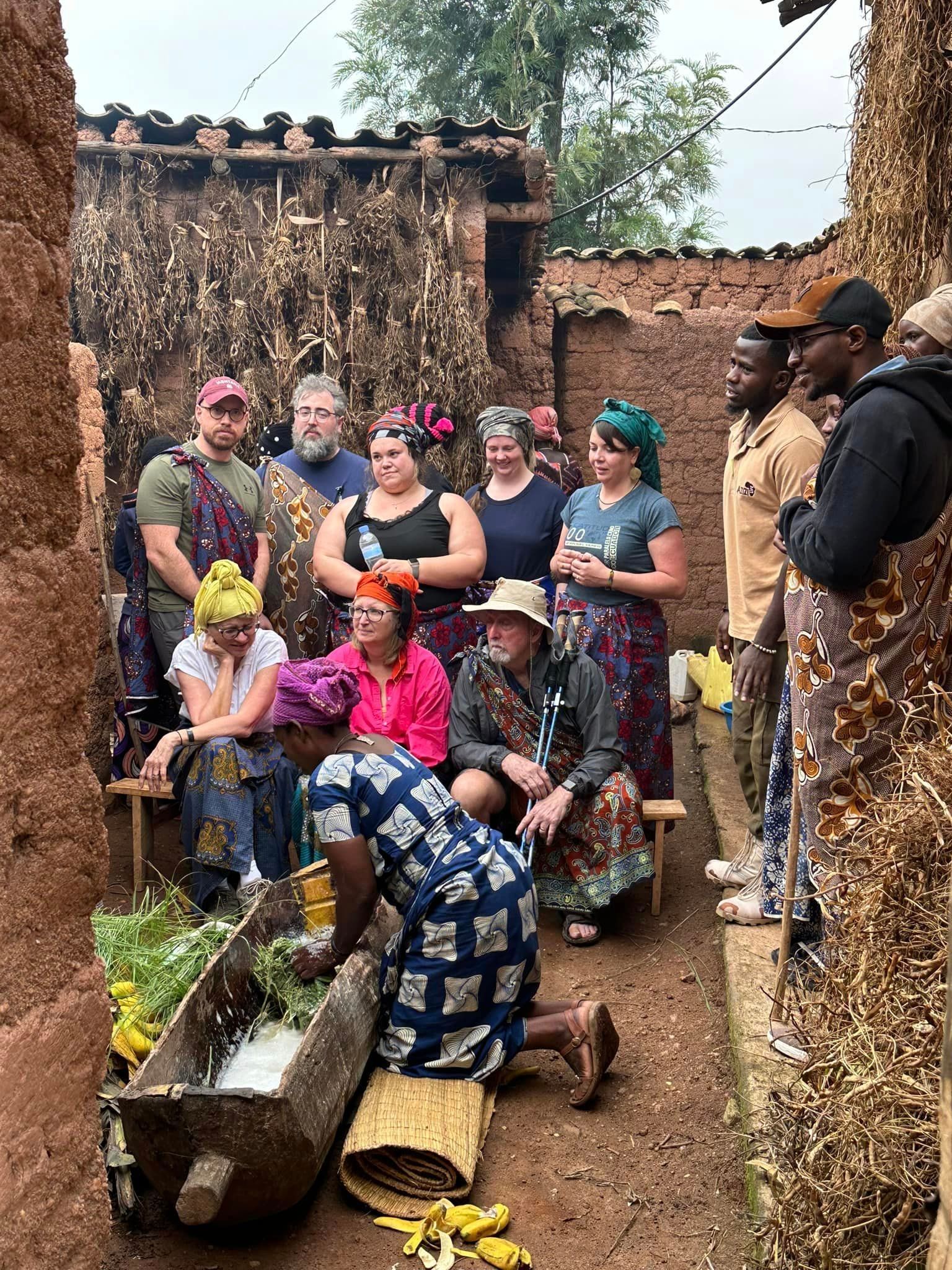 A group of people are standing around a woman kneeling down.