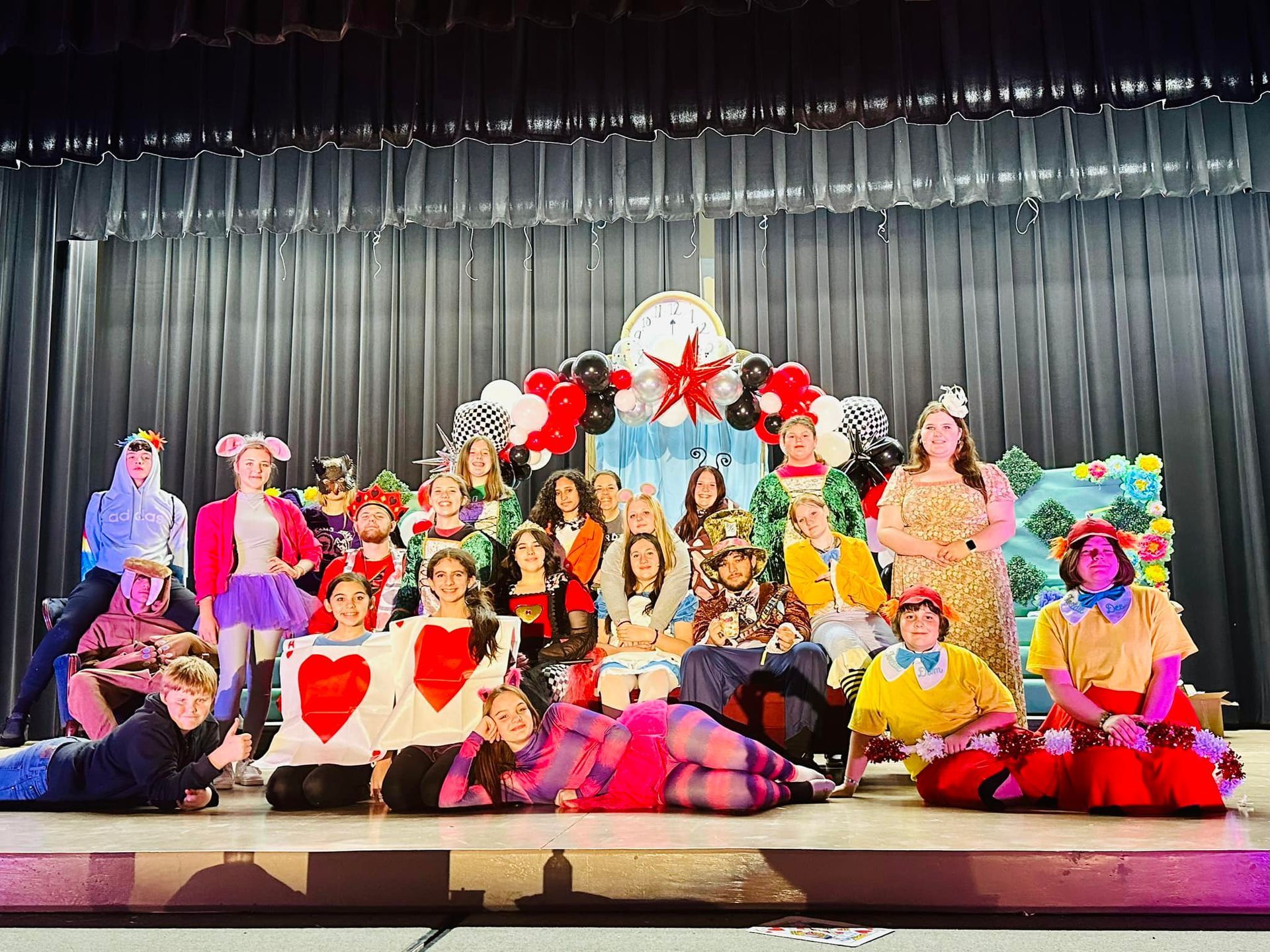 A group of people are posing for a picture on a stage.