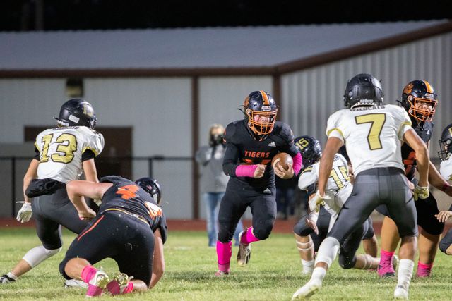 A group of football players are playing a game on a field.