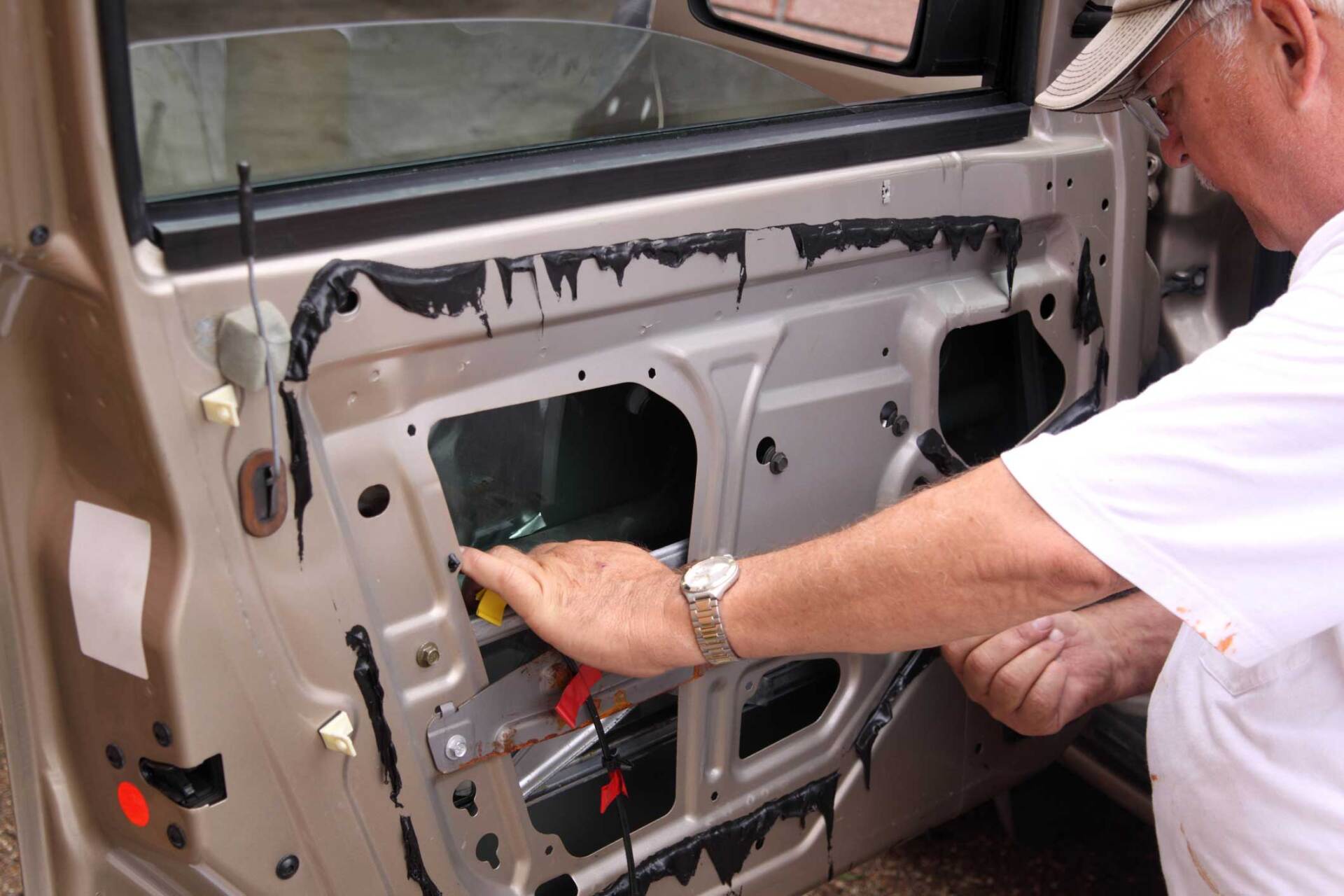 Man Fixing a Car Door — Hutchinson, KS — Mobile Service Auto Glass
