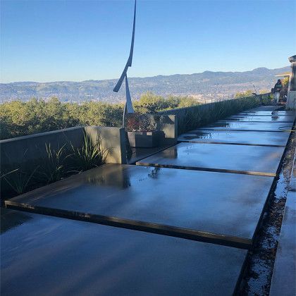 A concrete walkway with a view of the mountains in the background.