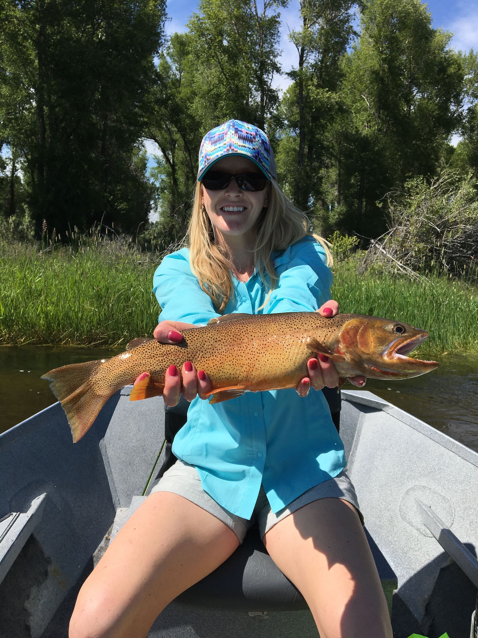 An angler at Jemas Ranch in Wyoming catches a brown trout.