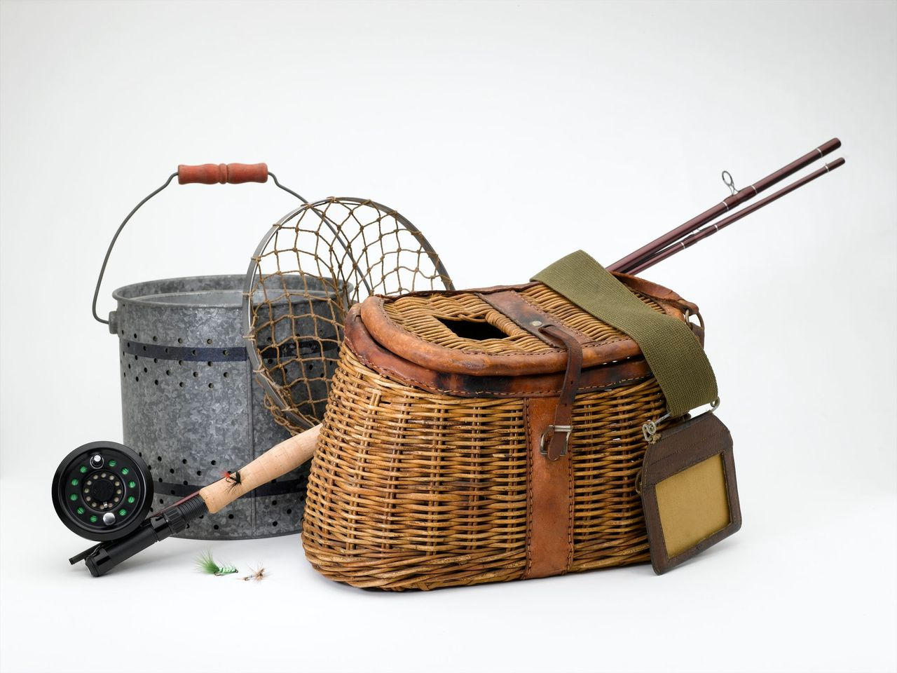 A wicker basket with a fishing rod in it