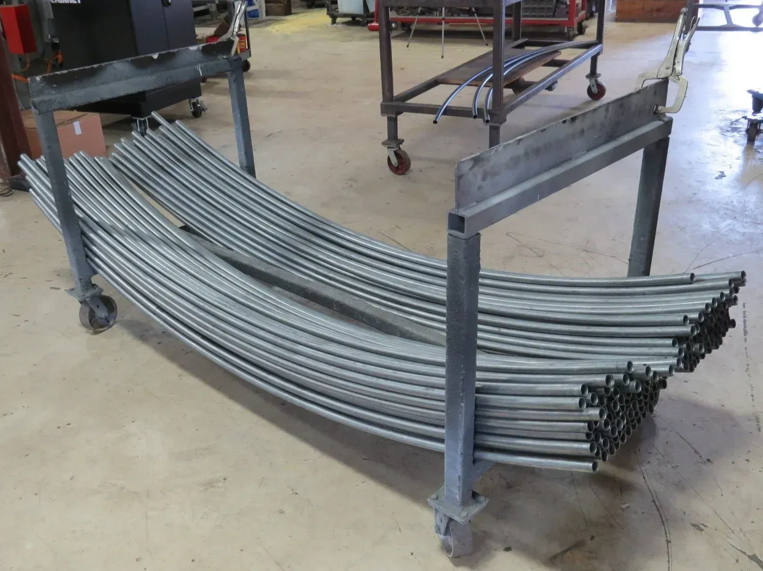 Blue industrial machine with metal components processing corrugated material.