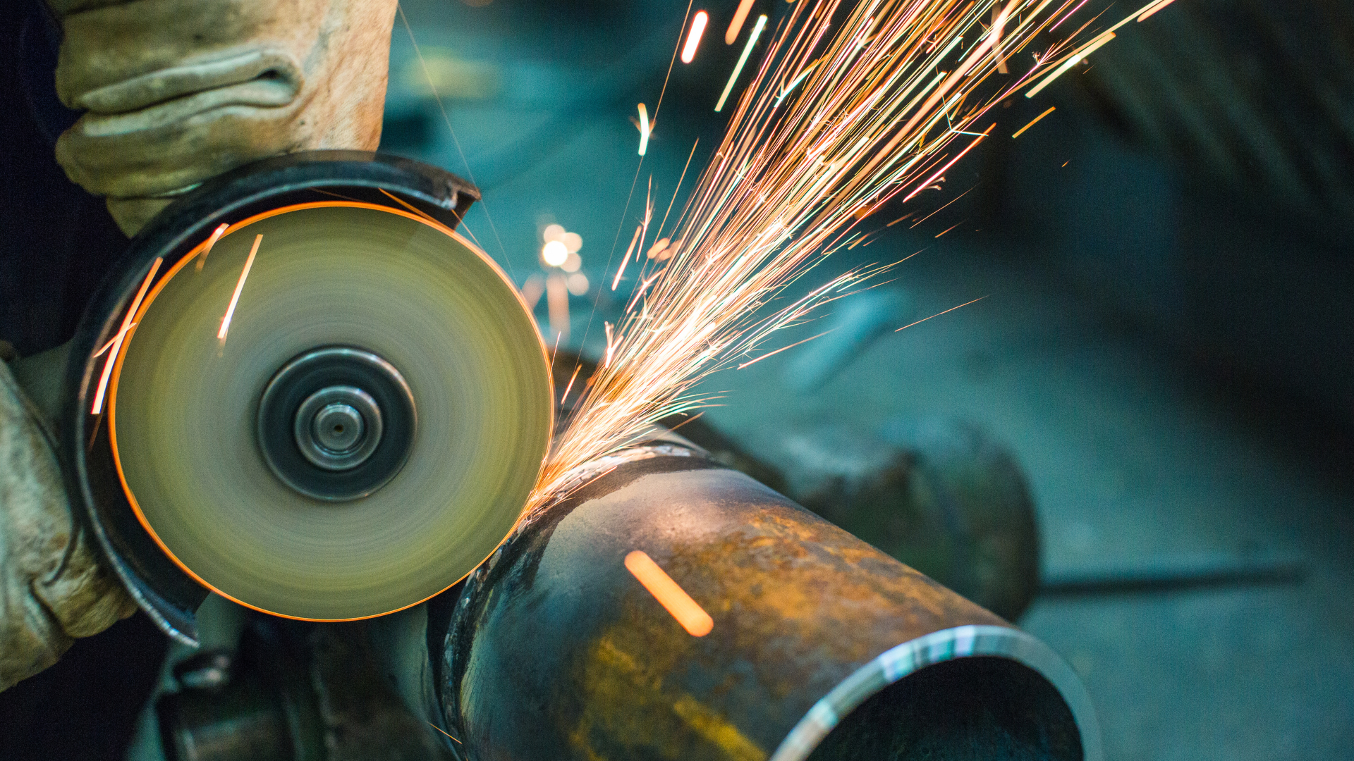 Metal machining equipment with a rotating part being ground.