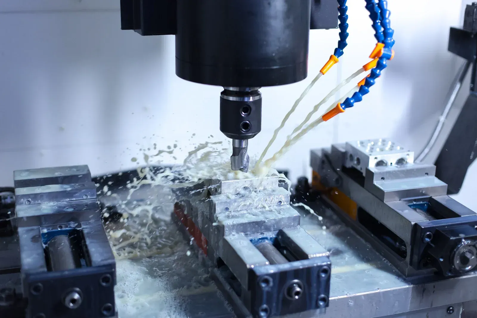 CNC machine milling metal, spraying coolant fluid.