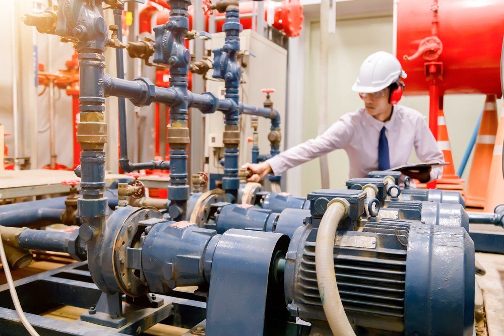 Man Checking Condenser Water Pump And Pressure Gauge — Wendy's Safety Services In Darwin, NT